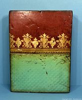 Full front view of the rectangular tile showing upper red field with gold motif and lower green textured field