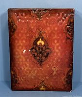 Front view showing full red-orange ornate design and minor surface scuff