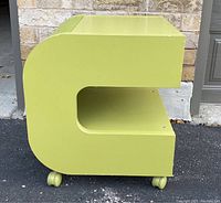 Side profile view showing C-shaped curved panels, two tiers, wheel placement and overall color.