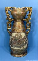 Front view of vintage Chinese Satsuma vase showing overall shape, gold-tone handles, and decorative motifs