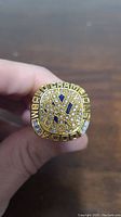 Top view of gold-tone 2000 New York Yankees World Series replica ring showing rhinestones and inscription 'World Champions'.