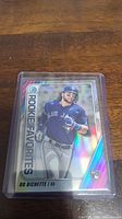 Photo of Bo Bichette Rookie baseball card in protective case, showing holographic and reflective surfaces and Bo Bichette in Blue Jays uniform.