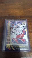 Front view of Henrik Lundqvist rookie hockey card inside a protective holder.