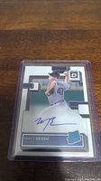 Photo of Matt Brash rookie autographed baseball card in plastic holder showing front with image and autograph.