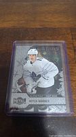 Front view of Mitch Marner hockey card in protective case showing all-star team designation and player image