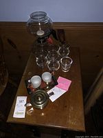 Full view of multiple Steuben and Bailey's glasses, espresso cups on tray, and brass pot