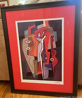 Framed abstract seriolithograph with red mat and black frame, showing full artwork with signature visible on the lower right corner