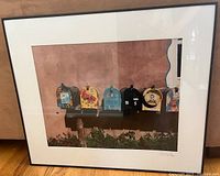 Framed photograph print of colorful decorated mailboxes by a stucco wall with cactus in foreground.
