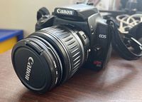 Close-up of Canon EOS Rebel XT camera body and attached Canon zoom lens