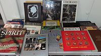 Wide view of the coffee table books arranged on a table showing titles and covers