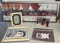 Framed panoramic photo print, empty photo frame with southwest design, two signed prints, and a brown mat card