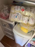 Various yarn skeins, mainly cream/white shades, some in original branded packaging.