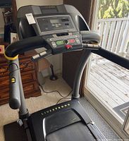 Front view of treadmill showing control panel and handles