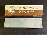 Combination sharpening stone with original box, showing the stone's surface and full box top label.