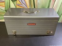 Front view of Craftsman tool box showing metal latches and logo plate.