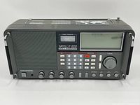 Front view showing speaker grille, control knobs, numeric keypad, LCD display and tuning dial