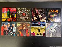 Photo showing all 8 vinyl 45 record sleeves in the lot with various 80s rock and pop artists.