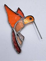 Front angled view showing stained glass hummingbird colors and metal beak