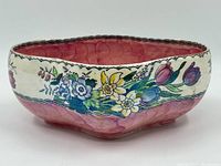Front angle view showing the bowl's shape, floral design, and pink mottled interior.