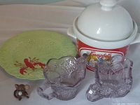 Full view of lot including Campbell's Soup tureen, lobster plate, cream and sugar glass set, and mouse figurine.