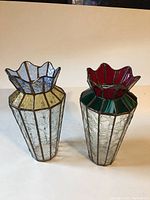 Front view of both stained glass vases side by side showing overall shape and color.