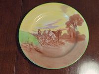 Full view of the Royal Doulton decorative plate showing painted farming scene with two horses and a farmer ploughing a field.