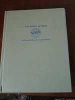 Cover of 'The World of Wade Collectable Porcelain and Pottery' guide book showing white hardcover with blue text and logo.