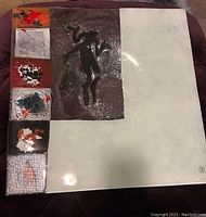 Top view of the square decorative art glass platter showing textured abstract design with inset colorful panels and smooth cream surface.