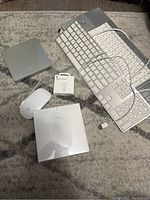 Photo displaying entire lot on carpet surface: 2 keyboards, 2 mice, USB optical drive, and Apple USB-C to Apple Pencil connector box