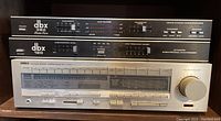 Overall view of two dbx units stacked above Yamaha receiver