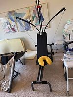 Front view of Bowflex Power Pro strength training system in a room with artwork on the walls.