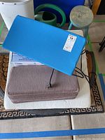 Blue and brown textured health cushions with power cord and mats underneath