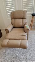 Front view of beige La-Z-Boy pleather recliner chair with footrest extended.