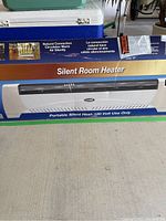 Photo of the Lasko Silent Room Heater box showing the product image and branding emphasizing natural convection and silent operation.