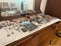 Overview of costume jewelry displayed on a dresser surface