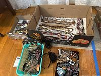 Wide view of box lot showing hair clips, bangles, earrings, and necklaces.