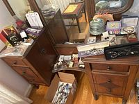 Wide view of dresser top showing assortment of jewelry, boxes and puzzle piece