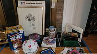 Photo of Honey Frosted Wheaties box, MLB framed artwork, Disney plates and mug, and Olympics soccer ball