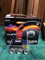 Microsoft Sidewinder Force Feedback Wheel box with Mars Solar Explorer model placed in front.