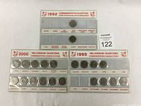 Image showing the three sets of quarters in clear holders: 1992 125th Anniversary of Confederation quarters, 1999 Millennium quarters, and 2000 Millennium quarters arranged by month and themes.