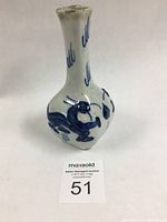 Photo of antique Chinese porcelain shrine flower vase showing narrow neck and bulbous body with cobalt blue dragon design