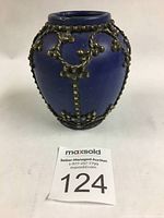 Front view of blue Moroccan vase showing cobalt blue glaze and decorative metal overlay with beaded geometric patterns.