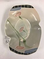 Top view of Gary Merkel serving dish showing floral underglaze decoration and geometric border details on porcelain surface.