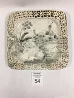 Top view of Harriet Hiemstra hand-built square earthenware platter displaying detailed still life drawing of fruit and flowers under crackle glaze with spotted rim detail.