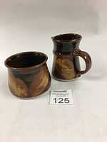 Photo of creamer and sugar container side by side showing shape and glaze pattern