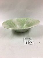 Side view of bowl showing gentle curve and spongeware pattern on exterior surface