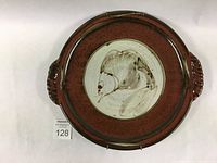 Top view of large round red Mason's Red glazed platter with twisted clay handles and central fish design.