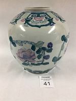 Full front view of vintage porcelain ginger jar with floral pattern showing shape and design