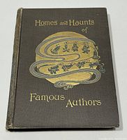 Front cover of the 1906 book 'Homes and Haunts of Famous Authors' with decorative gold and silver embossed text and design on dark cloth binding.