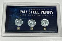 Front view of the 1943 Steel Penny Mint Mark three-coin collection in plastic display with blue background showing P, D, S mint marks.